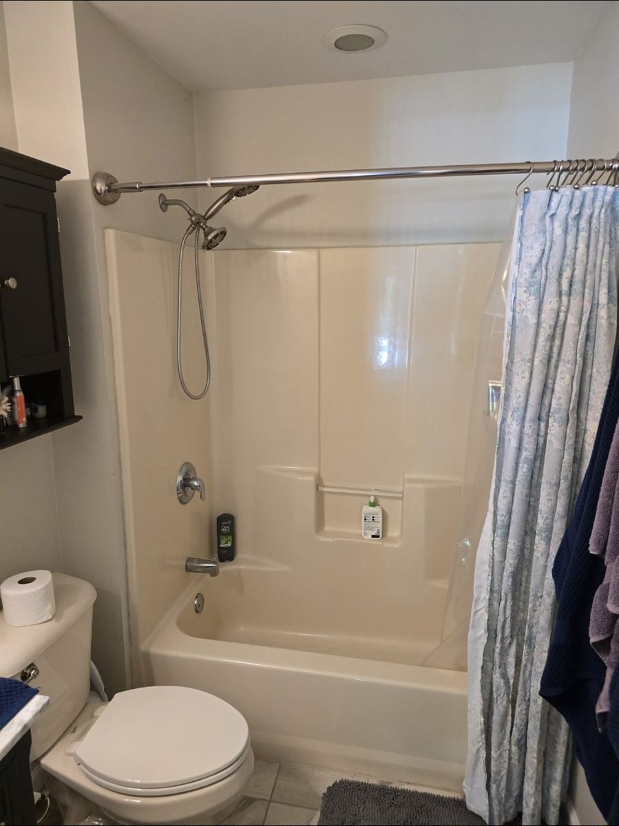 Bathroom before remodel: old tub and shower surround