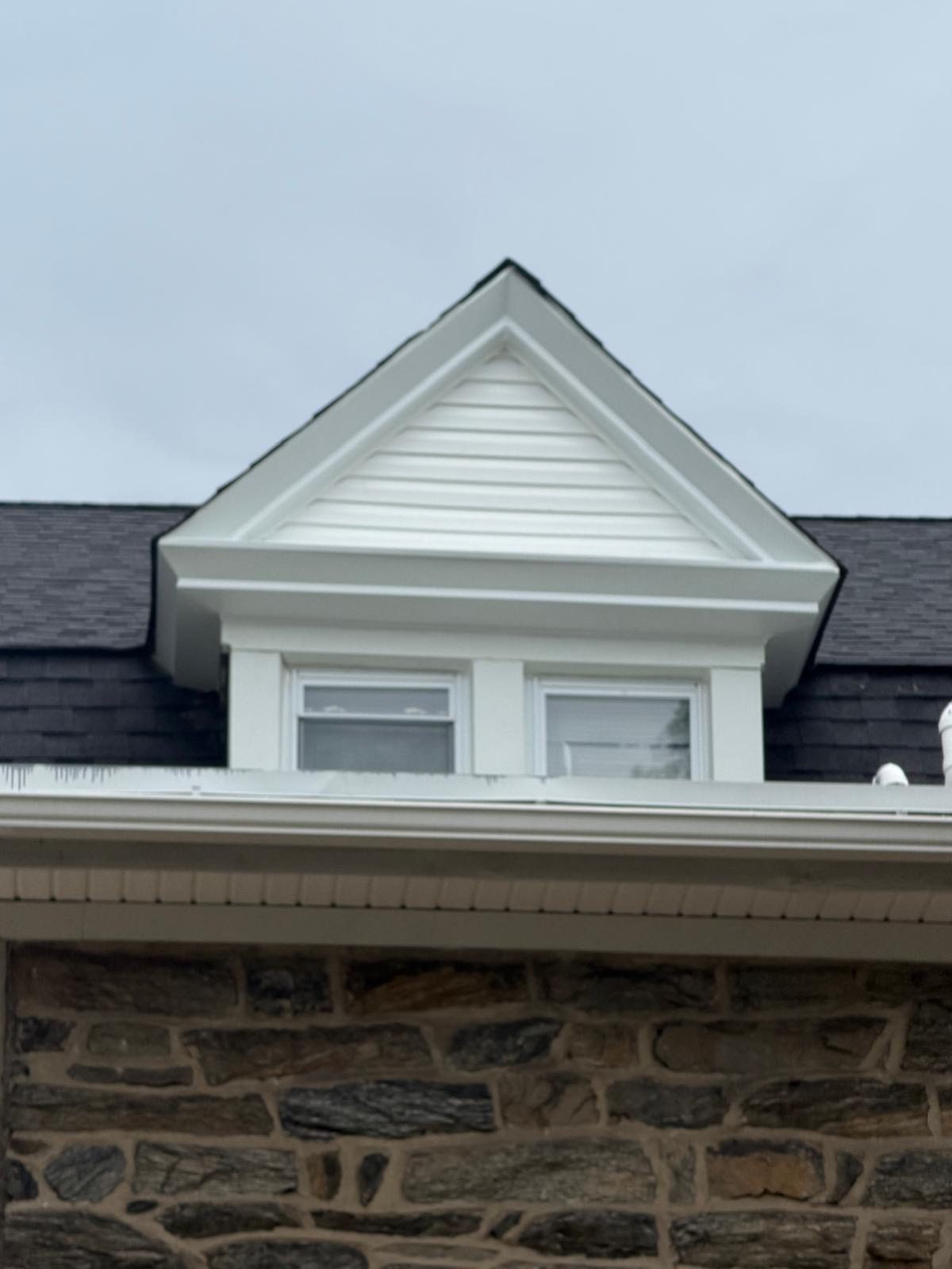 New dormer and shingle roof on a stone house by Sean Carry Construction