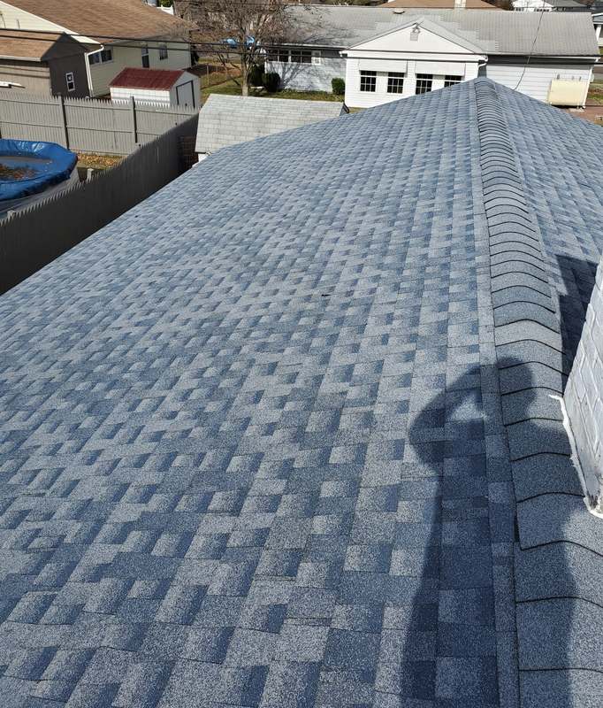 New blue-gray architectural shingles with a finished ridge cap